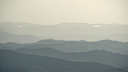 Fototapeta premium Generative AI, Minimalist Aerial View of Serene Mountain Ranges with Soft Cloud Layers
