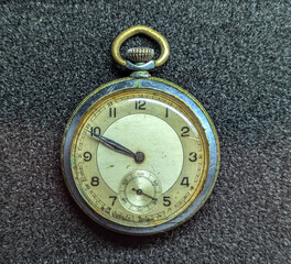 Vintage Pocket Watch on Textured Surface