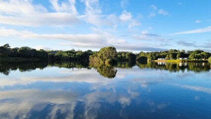 Reflection of clouds and tress in the lake