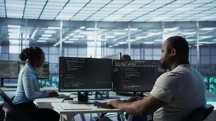 Sick IT professional in server hub sneezing while shielding data from potential threats using PC. Ill employee suffering from flu safeguarding data center against unauthorized access, camera B