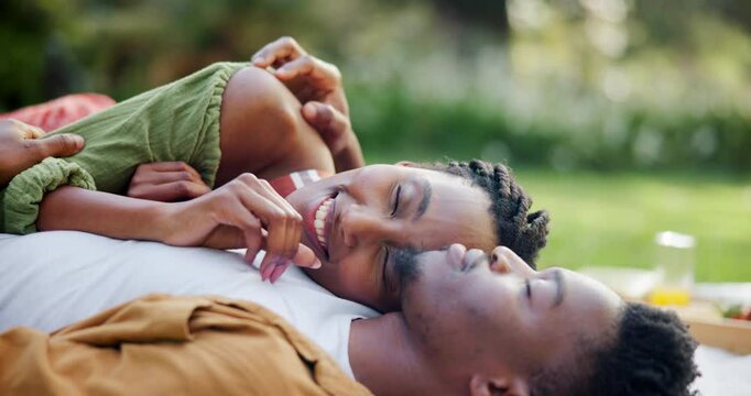 Black couple, relax and love for picnic on grass with romantic date, support and loyalty of anniversary. Smile, people and resting with embrace affection, relationship bonding and commitment outdoor