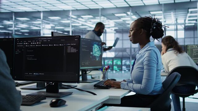 Portrait of smiling woman tasked with doing checkup on server room rows providing computing resources for different workloads. Happy admin investigating data center mainframes using PC, camera B