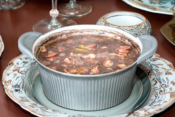 Traditional Brazilian feijoada in a rustic pan