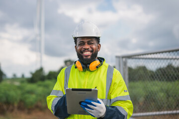 man in a yellow safety jacket is smiling and holding a tablet