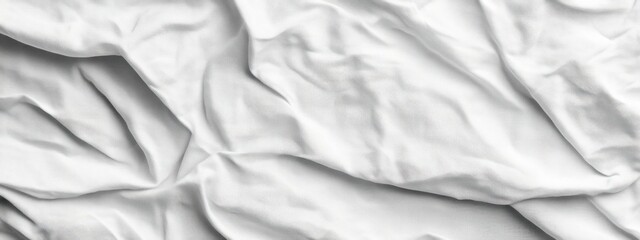Obraz premium A wrinkled white fabric texture creating a soft, neutral background.