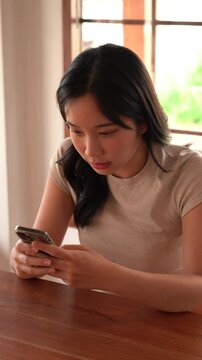Woman texting her friend and laughing