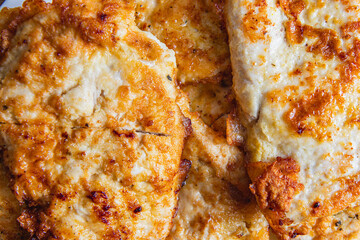 cooked chicken chops on white plate on table close up