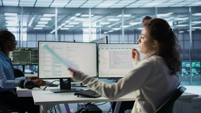 Employee overseeing server room, reading documentation paperwork, troubleshooting hardware. Supervisor doing inspection in server hub, reading technical files at computer desk, camera B
