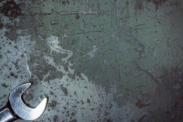 Wrench. Metal background with scratches. Garage service. Tools for repair. Free space for...