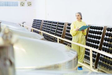 Quality control officer are examining in beverage manufacturing factory.