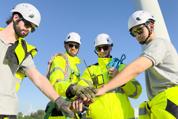 Team of electrical engineer is perform the inspection and maintenance of electric generating windmill turbine.