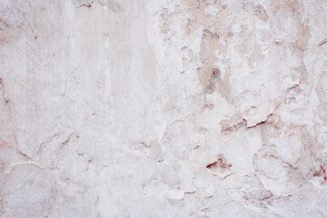 White concrete wall with natural defects. Fragment of the cement surface with natural texture....
