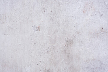 White concrete wall with natural defects. Fragment of the cement surface with natural texture. Monochrome palette of shades.