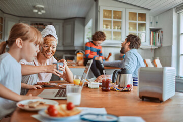 Happy family enjoying breakfast together in kitchen