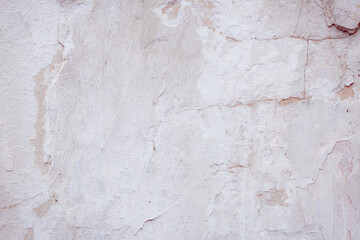 White concrete wall with natural defects. Fragment of the cement surface with natural texture. Monochrome palette of shades.