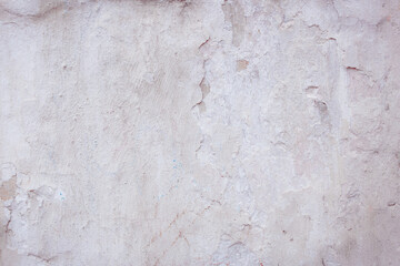 White concrete wall with natural defects. Fragment of the cement surface with natural texture. Monochrome palette of shades.
