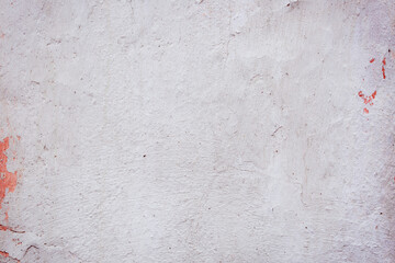 White concrete wall with natural defects. Fragment of the cement surface with natural texture. Monochrome palette of shades.