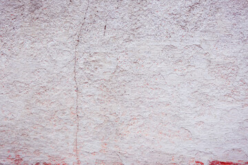 White concrete wall with natural defects. Fragment of the cement surface with natural texture. Monochrome palette of shades.