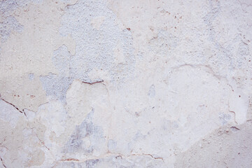 White concrete wall with natural defects. Fragment of the cement surface with natural texture. Monochrome palette of shades.