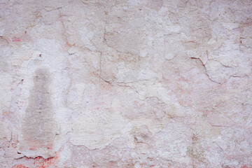 Grey peeling wall with natural defects. Fragment of the concrete shabby surface with natural texture. Red white palette of shades.