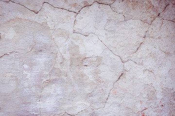 Grey peeling wall with natural defects. Fragment of the concrete shabby surface with natural texture. Red white palette of shades.