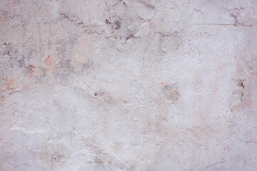 Grey peeling wall with natural defects. Fragment of the concrete shabby surface with natural texture. Red white palette of shades.