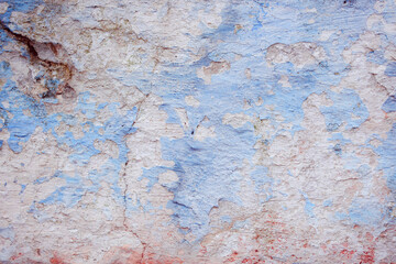 Blue peeling wall with natural defects. Fragment of the concrete shabby surface with natural texture. Blue white palette of shades.