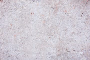 Grey peeling wall with natural defects. Fragment of the concrete shabby surface with natural texture. Red white palette of shades.