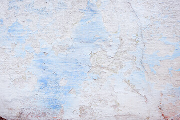 Blue peeling wall with natural defects. Fragment of the concrete shabby surface with natural texture. Blue white palette of shades.