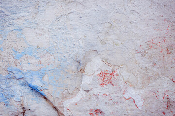 Fototapeta premium Blue peeling wall with natural defects. Fragment of the concrete shabby surface with natural texture. Blue white palette of shades.