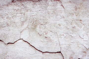 Obraz premium Grey concrete wall with natural defects. Fragment of the cement surface with natural texture. Natural cracked plaster on a light wall. Textured background for integration into the design.