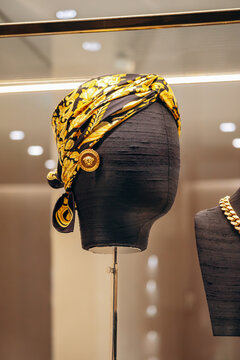 Bologna, Italy - October 6, 2024: Silk scarf and Versace earrings in a boutique window