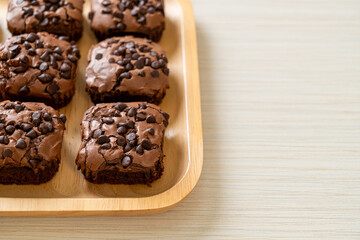 dark chocolate brownies topped by chocolate chips