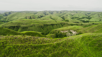 Green hills with grass and amazing growing fields and hills at Sumba
