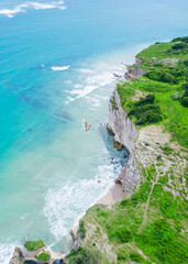 Top down view of a cliff with turquoise waters below © Balnyes Visuals