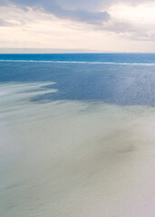 Sandy seashore with blue sea water. Beautiful paradise tropical island beach background
