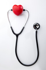 Red decorative heart and stethoscope isolated on white background