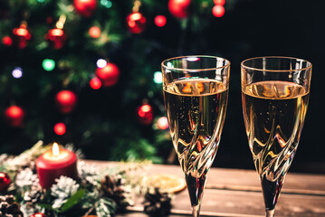 Champagne glasses on the background of a decorated Christmas tree. New Year