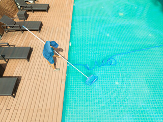 Pool maintenance with scoop net  and automatic robot cleaner.