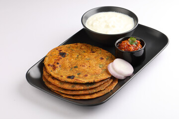   Indian flat bread Methi paratha or Methi thepla is a Indian breakfast dish served with curd and tomato chutney or dip 