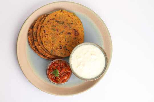   Indian flat bread Methi paratha or Methi thepla is a Indian breakfast dish served with curd and tomato chutney or dip 