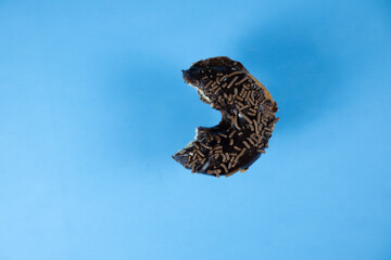 Bitten donut on colorful background.