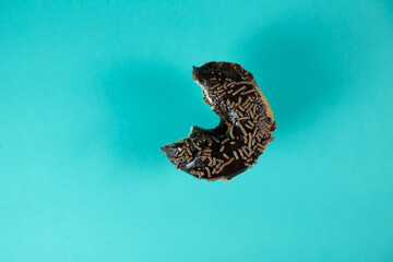 Bitten donut on colorful background.