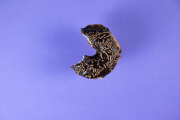Bitten donut on colorful background.
