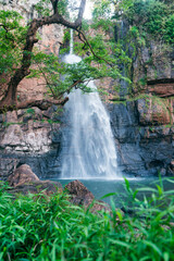 Tropical landscape. Beautiful hidden waterfall in rainforest. Adventure and travel concept. Nature background