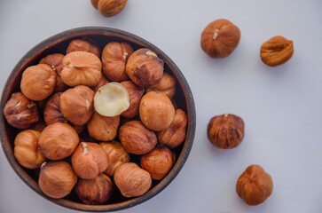 Fototapeta premium hazelnuts peeled in a plate on a light background
