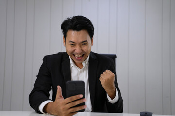 White collar worker is using smart phone for investment.