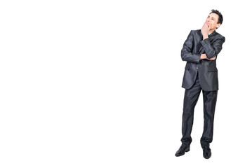 Dreamy businessman touching chin and thinking in studio