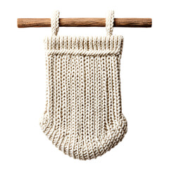 A handwoven, cream-colored decorative hanging reminiscent of vintage craftsmanship, suspended from a wooden rod against a black background.