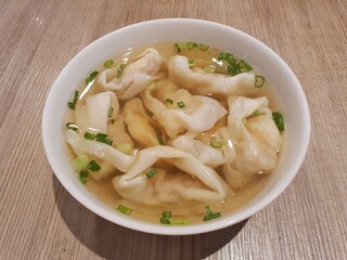 Chinese wonton dumplings soup. Chinese wonton dumplings. Chinese wonton traditional stuffed dumplings in soup with spring onion